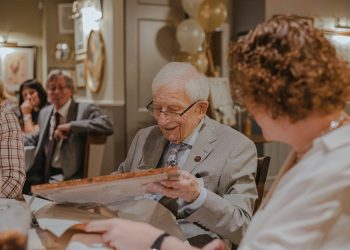 smiling man holding box